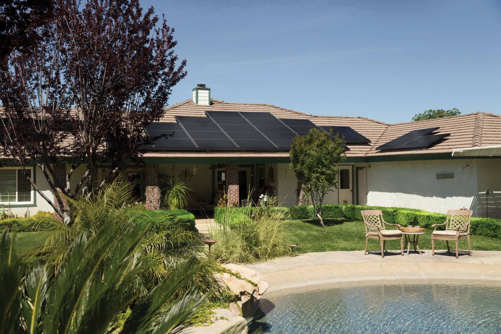 Southern California home with black solar panels on a tile roof