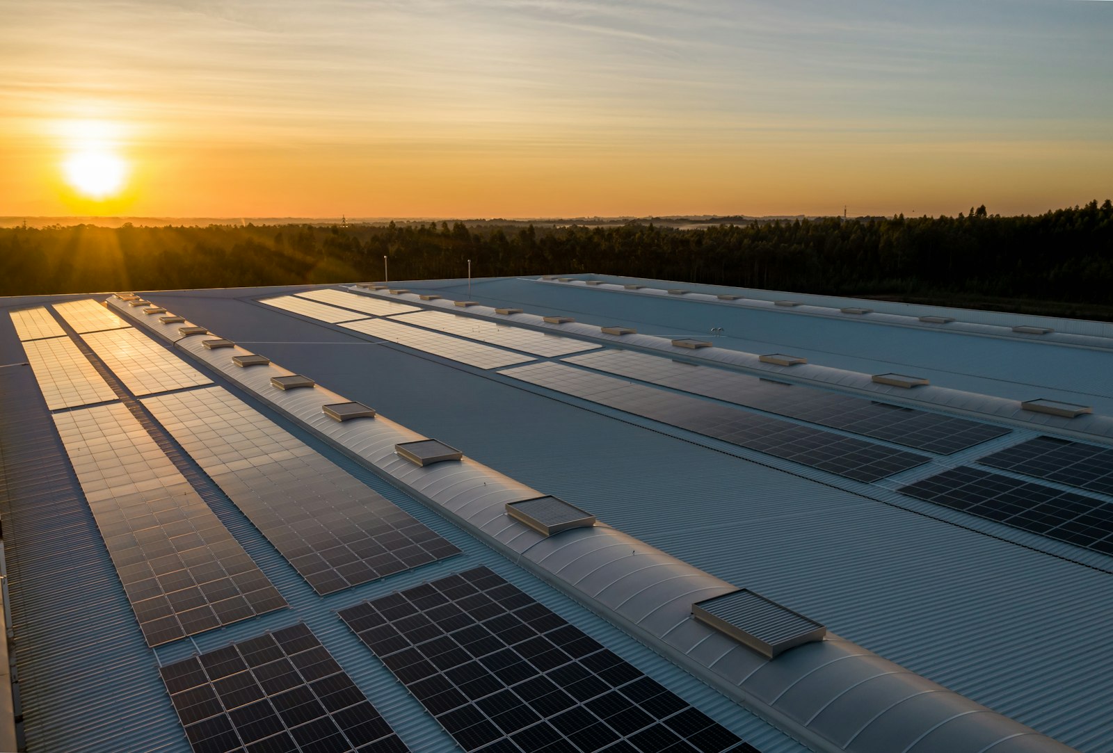 Commercial rooftop solar array at sunrise